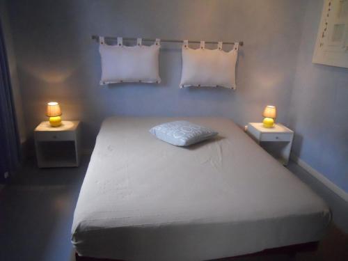 米米藏La Garluche的一间卧室配有一张带两个灯的床