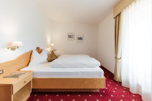 卡斯泰尔贝洛Hotel Bauhof的配有一张床和一张书桌的酒店客房