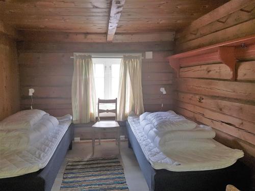 InnfjordenLensmansgarden Marteinsgarden的木间设有两张床,设有窗户