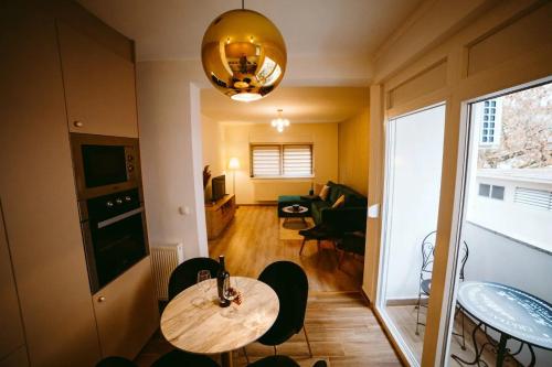 斯拉沃尼亚布罗德Apartman Gold的一间带桌椅的房间和一间客厅