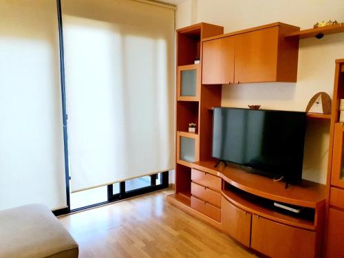 瓦伦西亚Apartamento ideal para familias的娱乐中心设有带平面电视的客厅