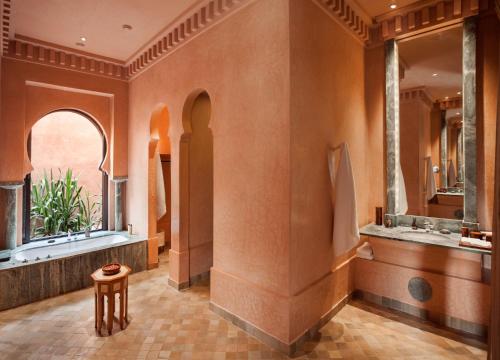 马拉喀什Amanjena Resort的带浴缸、水槽和镜子的浴室