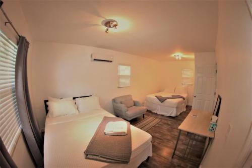 迈阿密Upper East Side Oasis的一间卧室配有一张床、一张沙发和一把椅子