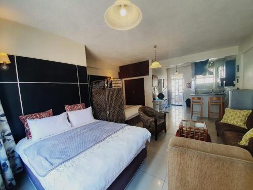 德班Marlborough Durban Beachfront South Beach luxury Holiday Apartments on Marine Parade!的一间带大床的卧室和一间客厅