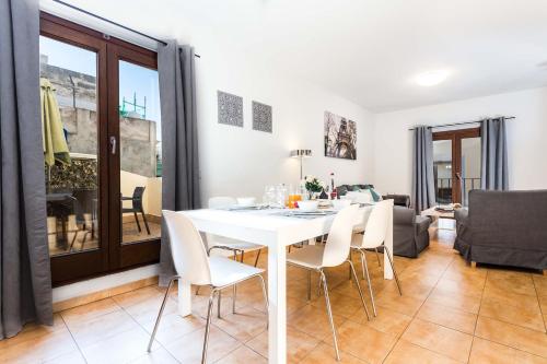 马略卡岛帕尔马Mallorca Suites - Turismo de Interior的白色的用餐室配有白色的桌椅