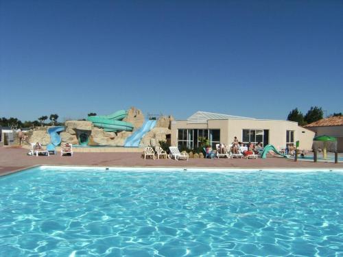 圣伊莱尔德里耶Mobil home BASSET au camping à St Hilaire de Riez 400m de la mer的一个带水上公园的大型游泳池