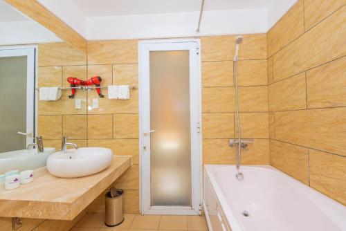 海阳海阳荷丛酒店的浴室配有盥洗盆和浴缸。