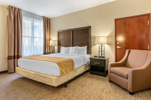 阿伦派克艾伦帕克/迪尔伯恩康福特套房酒店的配有一张床和一把椅子的酒店客房
