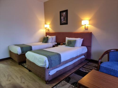 Hotel Nirvana by Luxury International客房内的一张或多张床位