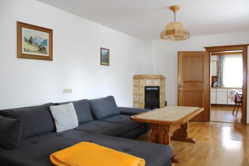 平茨高谷地霍勒尔斯巴赫Ferienwohnung Innerhofer的客厅配有蓝色的沙发和木桌