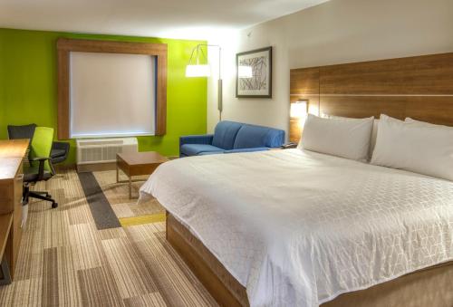 林垦林肯机场智选假日酒店的酒店客房配有一张床、一张桌子和一把椅子。