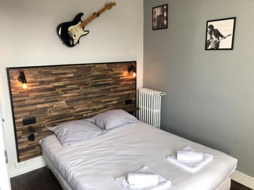 南特雷诺瓦酒店的墙上有吉他的房间的一张床位