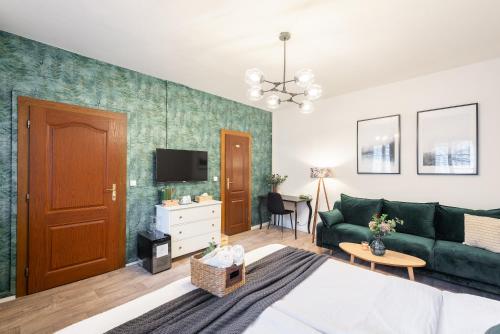 利托梅日采杜比纳旅馆的客厅配有绿色沙发和电视