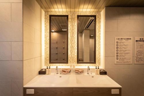 广岛Super Hotel Hiroshima Yagenboridori的浴室设有大白色水槽和镜子