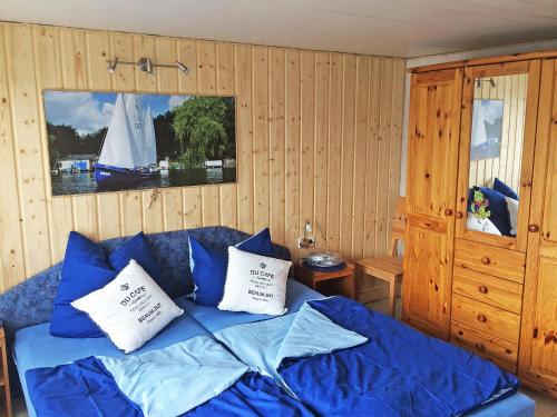 滨湖克拉科Chalet Güstrower Chaussee by Interhome的一间卧室配有一张带蓝色床单和枕头的床。