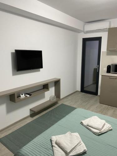 北马马亚-讷沃达里Studio Ra Mamaia-Nord的白色的客房配有床和平面电视。