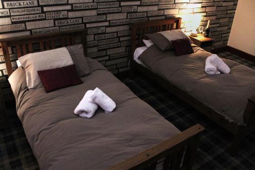 DirletonThe Castle Inn的客房内的两张床和毛巾