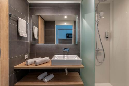 昂蒂布Lagrange Apart'Hôtel Antibes Olympie的一间带水槽和淋浴的浴室