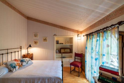 多尔切阿夸Agriturismo dalla Mimmi的一间卧室设有一张床、一台电视和一个窗口。