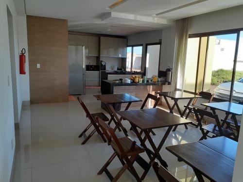 Chapadão do SulRosa Vilma Hotel的厨房以及带木桌和椅子的用餐室。