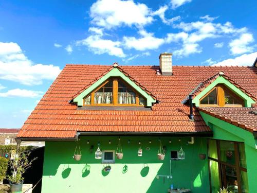 克伦特尼采Penzion Villa Verde Moravia的一座带红色屋顶的绿色房子