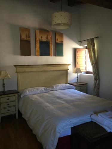 拉伊鲁埃拉Casa Clemente I的卧室配有一张白色大床和2个床头柜
