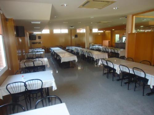 阿尔卡拉兹卡萨米克尔酒店-餐厅的一间设有白色桌椅的用餐室