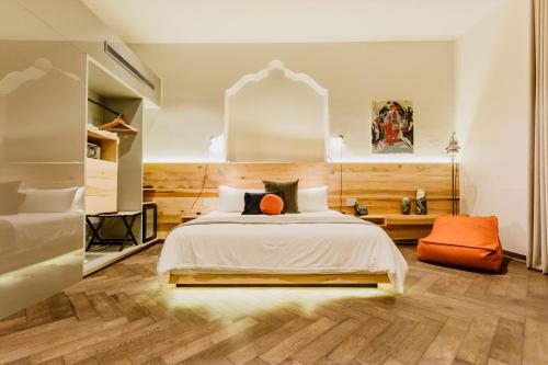 克雷塔罗Tá Hotel de diseño的一间卧室配有一张带橙色枕头的床