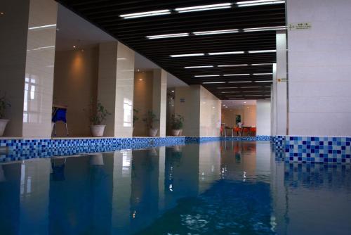 达累斯萨拉姆Lark Hotel的蓝色瓷砖建筑中的游泳池
