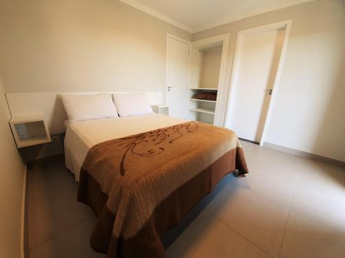 坎波斯杜若尔当Winter Garden - Guest House - Campos Do Jordão的一间卧室配有一张带棕色毯子的床