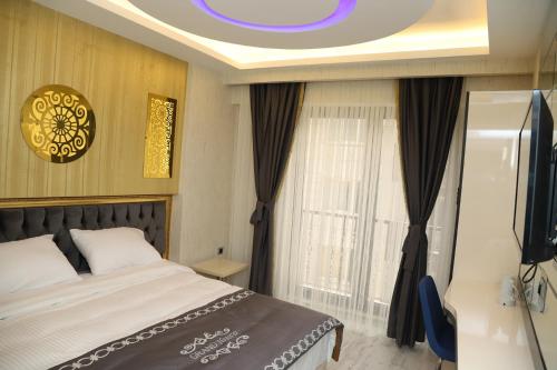 伊斯坦布尔The Grand Tower Hotel的一间卧室配有一张床和一台电视。