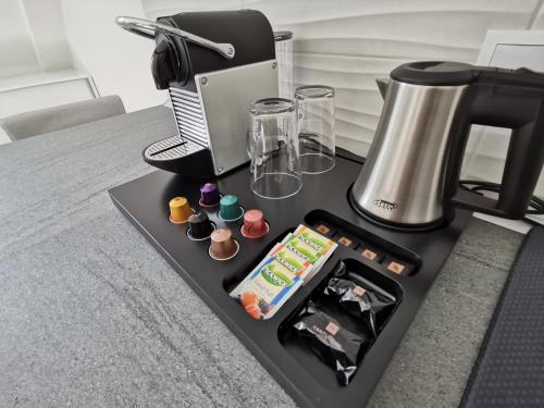 佩奇Antracit Apartman的一张桌子、咖啡壶和咖啡机