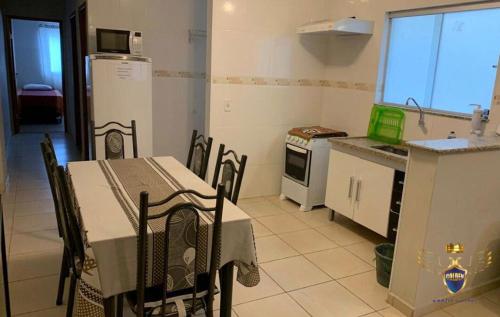 阿帕雷西达Golden Apart Hotel的厨房配有桌椅和冰箱。
