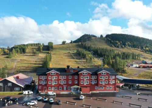TranstrandKläppen Ski Resort的一座红色的大建筑,后面有一座小山