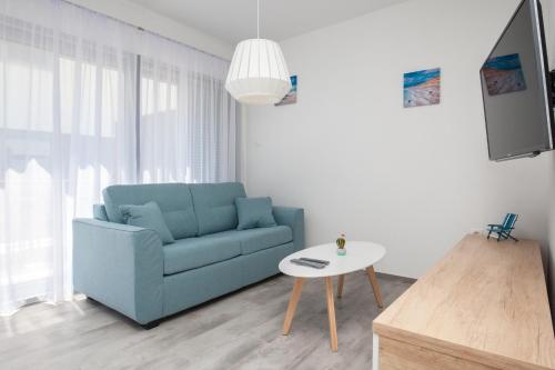 波尔Apartments Dva Galeba的客厅配有蓝色的沙发和桌子