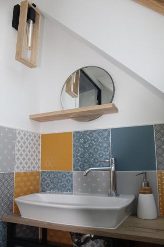 班戈Maison Belle-Ile en Mer的一间带水槽和镜子的浴室