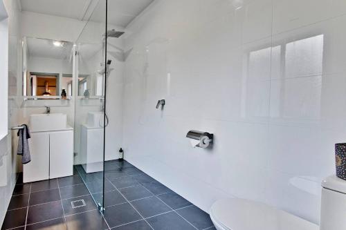 古尔本Elements Of Goulburn的带淋浴和卫生间的白色浴室