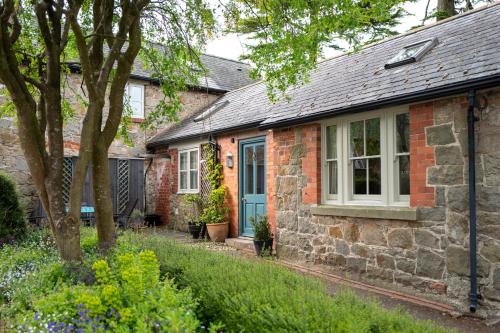 奥斯威斯Courtyard Cottage的一间设有蓝色门窗的砖房