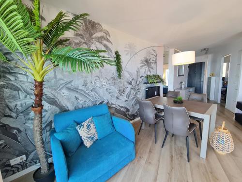 戛纳西方戛纳 - 全景公寓的客厅配有蓝色的沙发和棕榈树