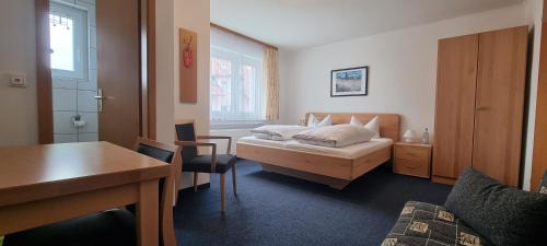 农嫩霍恩赛德酒店的卧室配有1张床、1张桌子和1把椅子