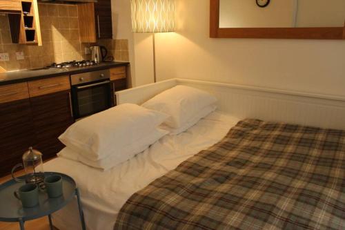 皮布尔斯The Snug, a great flat in the heart of Peebles.的一间小卧室,配有一张床和一张桌子