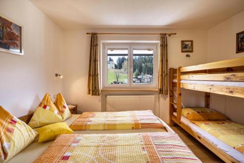 特伦托Ferienwohnung Zirme Gasser的一间卧室设有两张双层床和一扇窗户。