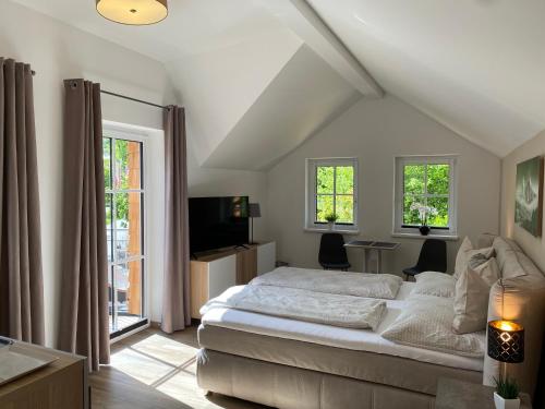 巴德伊舍Im Kurpark的一间卧室设有一张床、一台电视和窗户。