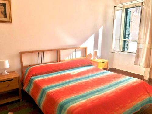 维耶斯泰Rocca Sul Mare Hotel的一间卧室配有一张色彩缤纷的床和窗户