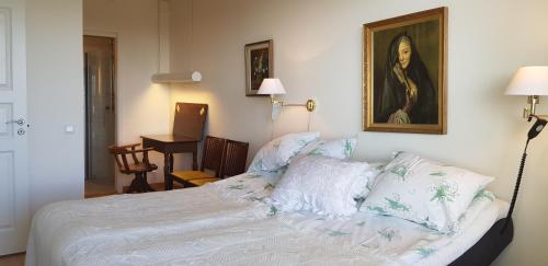维斯比Snäck Apartment floor 11 sea view的卧室,配有一张床和一张女人的肖像