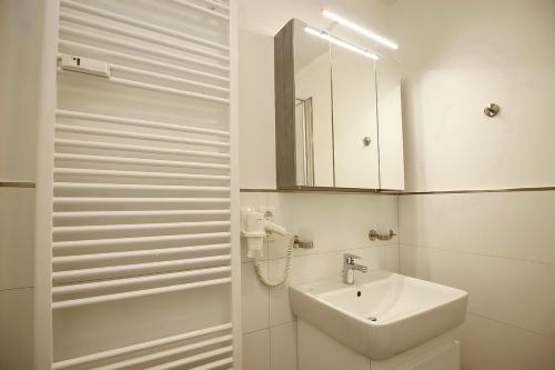 博尔滕哈根Sünnslag Wohnung 039的白色的浴室设有水槽和镜子