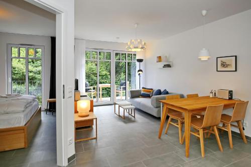海利根达姆Linden-Palais Wohnung 21的一间卧室和一间带桌子及沙发的客厅