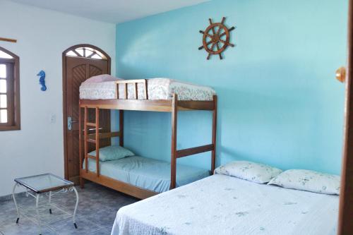 巴拉那州蓬塔尔Apartamento Beira Mar的一间卧室设有两张双层床和蓝色的墙壁