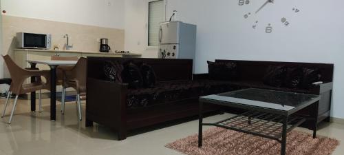 古莱比耶Dar Lebharr Kélibia的客厅配有黑色沙发和桌子