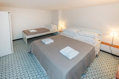瓦里格提Le Casasse "Vico Mendaro 10"的一间卧室配有一张床,上面有两条毛巾